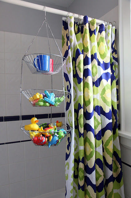 Use a hanging tiered fruit basket to hold bath toys